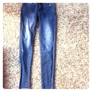 Denim blue jeans with back pockets and button